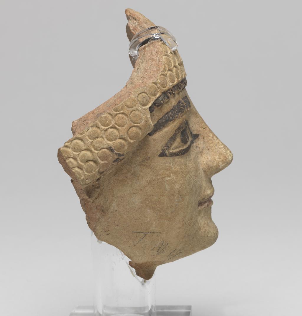 An image of Figure/Head. Male head, wearing cap. Production Place: Cyprus. Find Spot: Salamis, Temple of Apollo, Cyprus. Clay, moulded, height 101 m, width 0.077 m, 600-501 B.C. Archaic Period.