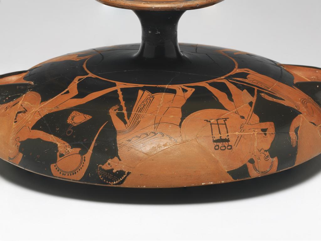 An image of Vessel/Cup. Painter of Berlin 2268 (vase-painter, ca. 530-500 BC). (A,B) warriors and draped youths, one with flower, snake, dog, tripod (I) draped man with staff. Production Place: Athens. Find Spot: Vulci Etruria Italy. Red figured, clay, diameter, 0.273 m, height 0.106 m, width 0.351 m, diameter, 0.146 m. 500-490 B.C. Archaic Period.