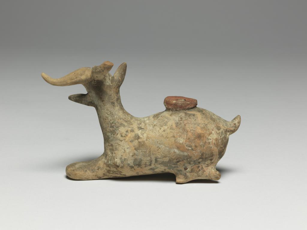 An image of Cosmetic Vessel. Goat, perfumed-oil container. Production Place: East Greece Turkey. Find Spot: Cyprus. Clay, height 0.083 m, length 0.135 m, 600-501 B.C. Archaic Period.