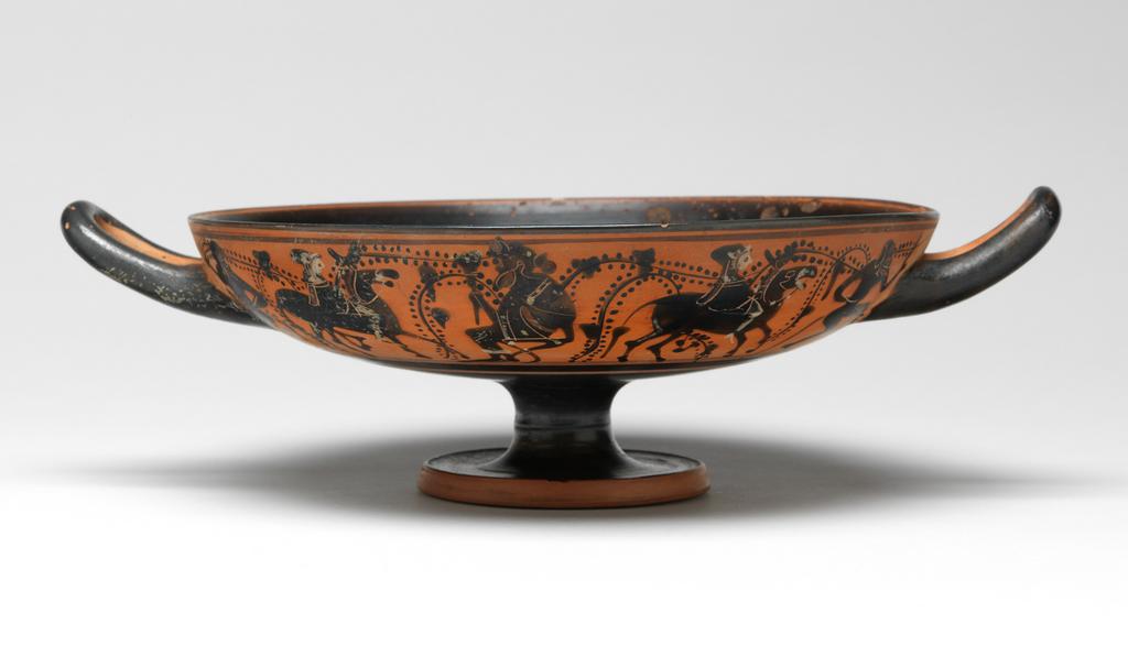 An image of Cup/Vessel. Dionysos, satyrs and donkeys, dolphin. Production Place: Athens. Clay, black-figured, height 0.083 m, width 0.273 m, diameter 0.202 m, diameter 0.068 m, 490 B.C. Archaic Period.