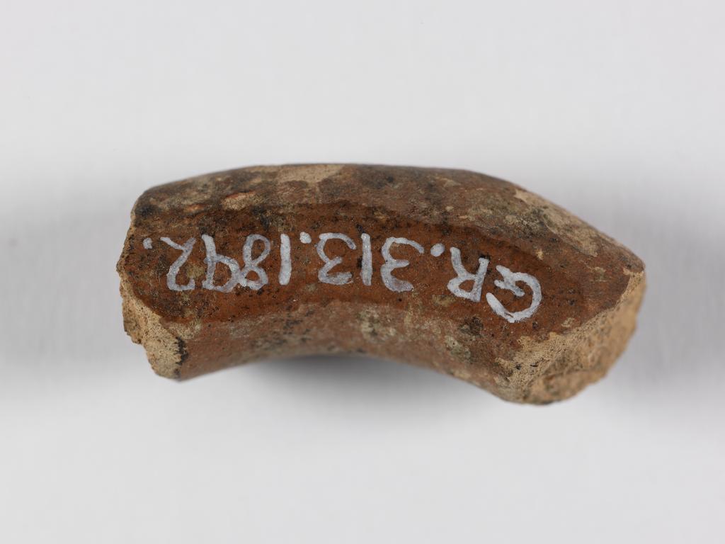 An image of Handle fragment. Find Spot: Tamassos, Cyprus. Clay, depth 0.01 m, width 0.027 m. Iron Age.