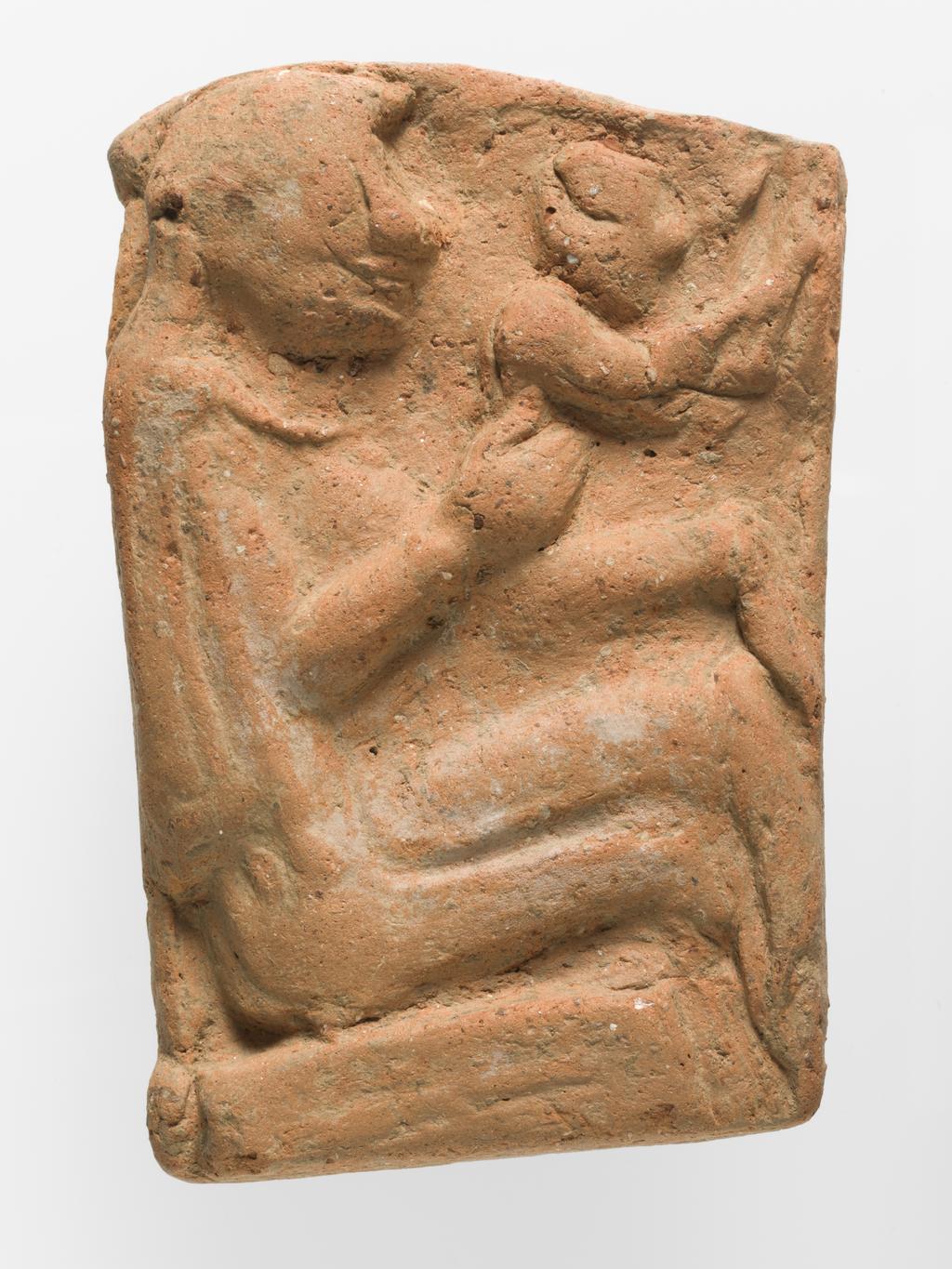 An image of Architectural element. Relief of woman and child. Find Spot: Lato (Goulas), Greek Islands, Crete. Clay, height 0.09, m, width 0.06 m, 700 B.C. to 601 B.C. Archaic Period.