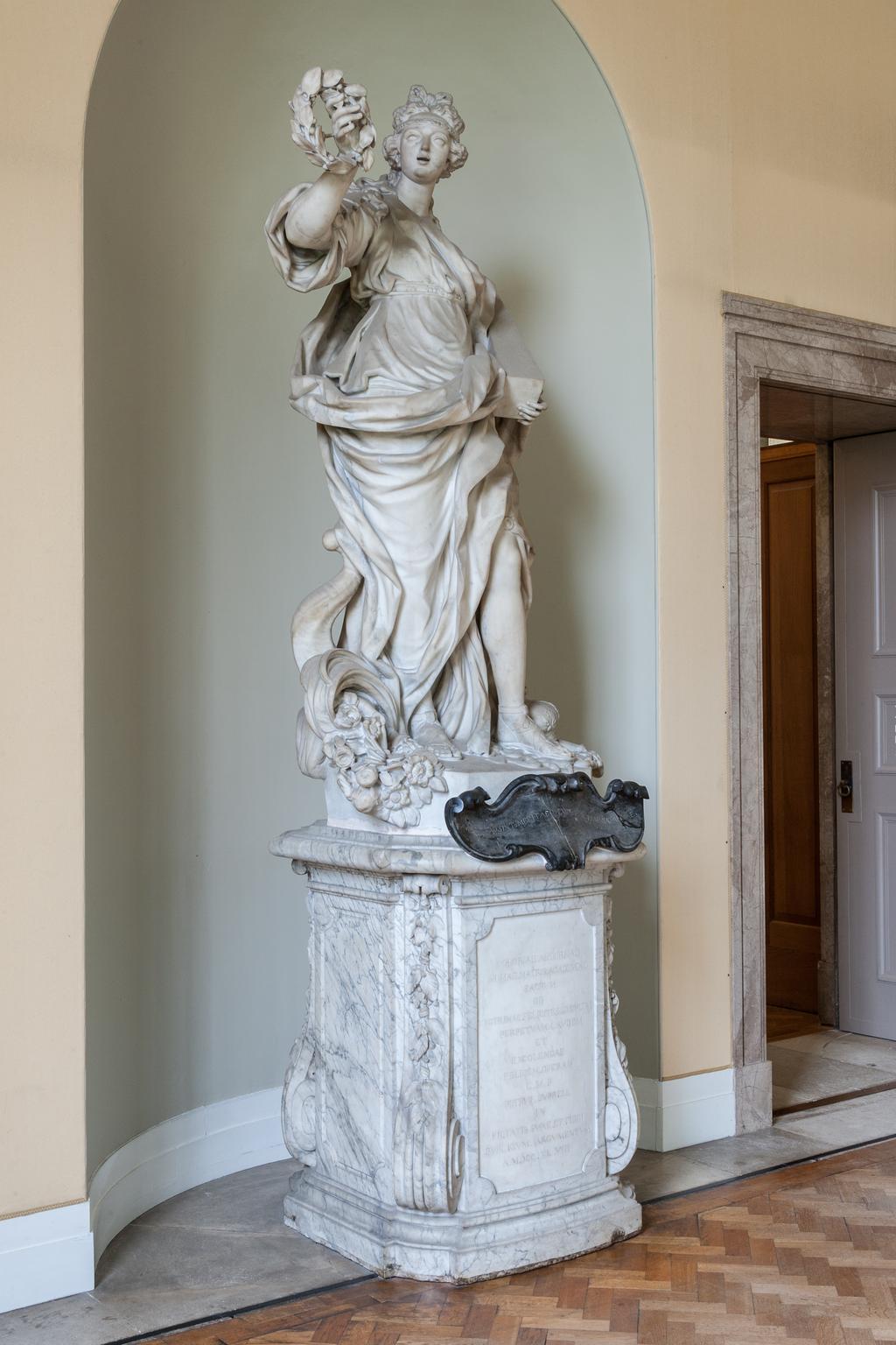 An image of BARATTA, Giovanni (the Younger)GloryCarrara white marble, carved in the round; on grey veined marble pedestal, with black marble cartouche. A full length figure of a woman, representing 'Glory' supported on a high pedestal.The inscription on the black marble is not the original as devised by James Brydges, first Duke of Chandos (1784-1744) which read: GLORIA MARLBURI, LAURO TUA TEMPORA CINGIT/DIVA LUBENS QUORSIUM? PAR DECUS INDE REFERT.C.1715Florence, Italy