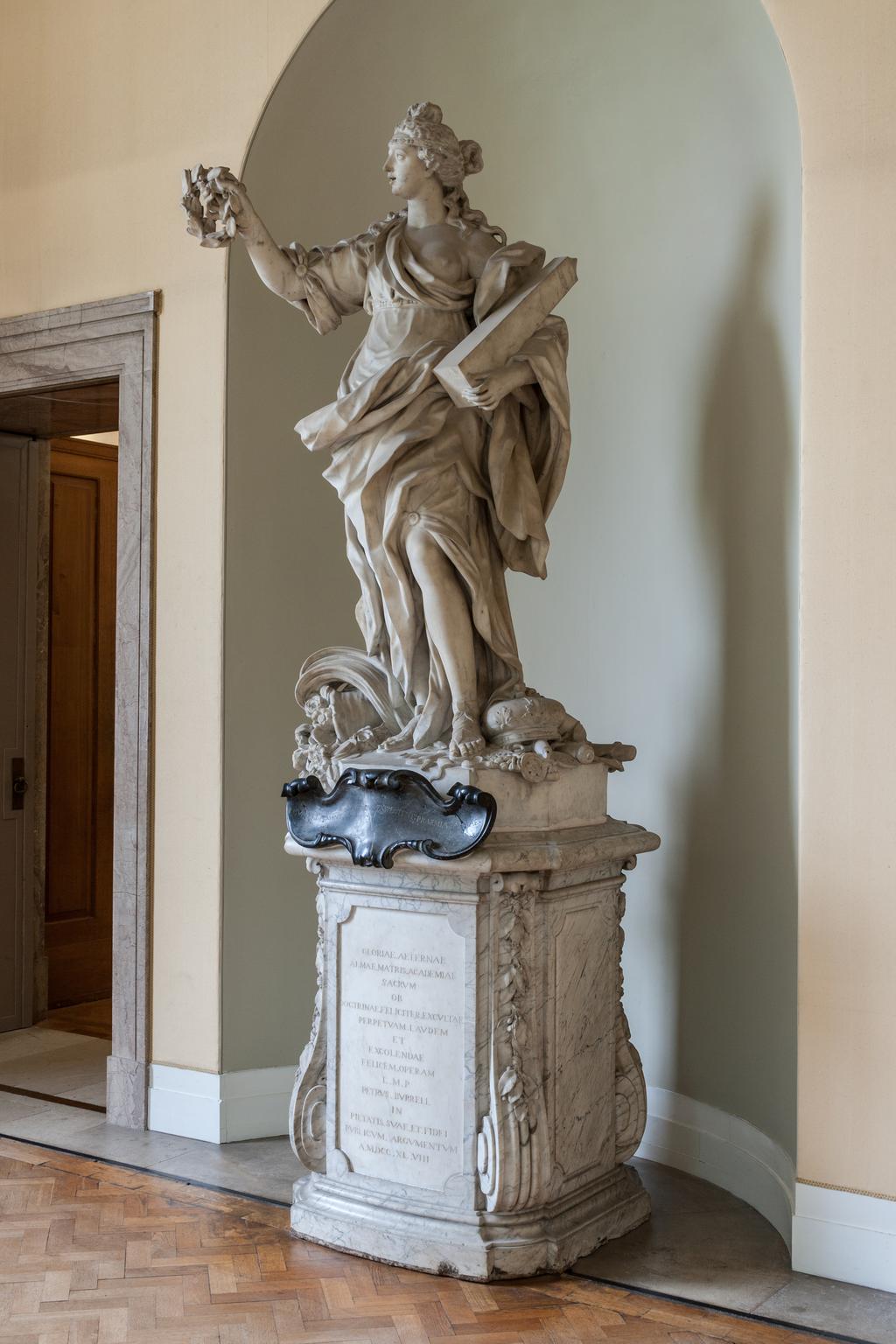 An image of BARATTA, Giovanni (the Younger)GloryCarrara white marble, carved in the round; on grey veined marble pedestal, with black marble cartouche. A full length figure of a woman, representing 'Glory' supported on a high pedestal.The inscription on the black marble is not the original as devised by James Brydges, first Duke of Chandos (1784-1744) which read: GLORIA MARLBURI, LAURO TUA TEMPORA CINGIT/DIVA LUBENS QUORSIUM? PAR DECUS INDE REFERT.C.1715Florence, Italy