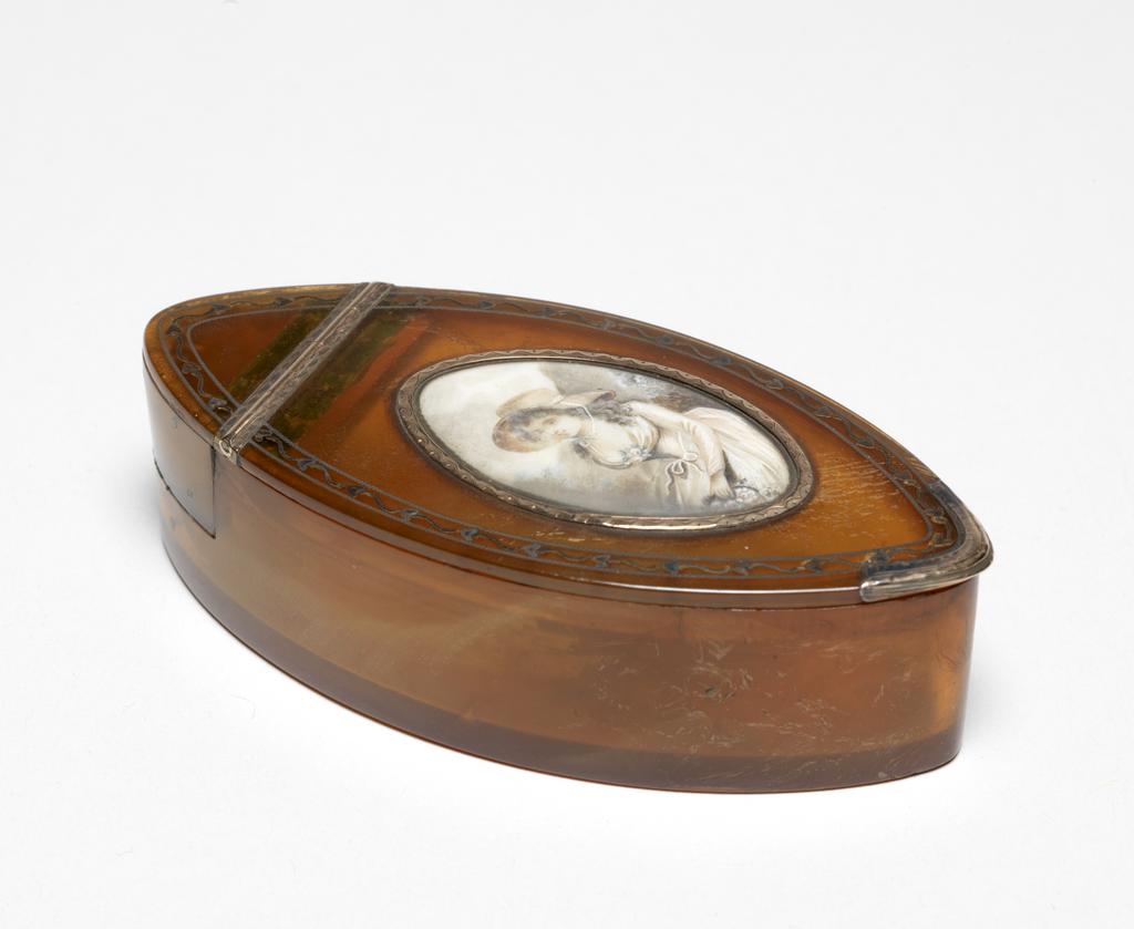 An image of Snuff box. Objets de vertu. Girl with basket of roses. Unknown maker, England, probably. Navette-shaped horn box with gold piqué work; the lid set with a miniature of a seated girl holding a basket of roses. Pointed oval (navette-shaped) with straight sides. The top of the flat lid is inlaid with a gold piqué wriggle work border; in the centre is a navette-shaped miniature in faded browns, blues and pinks depicting a seated girl, facing three-quarters left, wearing a hat and holding a basket of pink roses. The gold mount round the miniature, the hinge and the thumbpiece are engraved with bright cut borders. A vacant oval impressed cartouche in the base indicates some decoration is missing. Horn with gold mounts and inlaid gold piqué work; the lid set with a miniature painted in watercolour and bodycolour probably on card. Height, whole, 2.8 cm, length, whole, 9.5 cm, width, whole, 4.5 cm, 1780-1800.