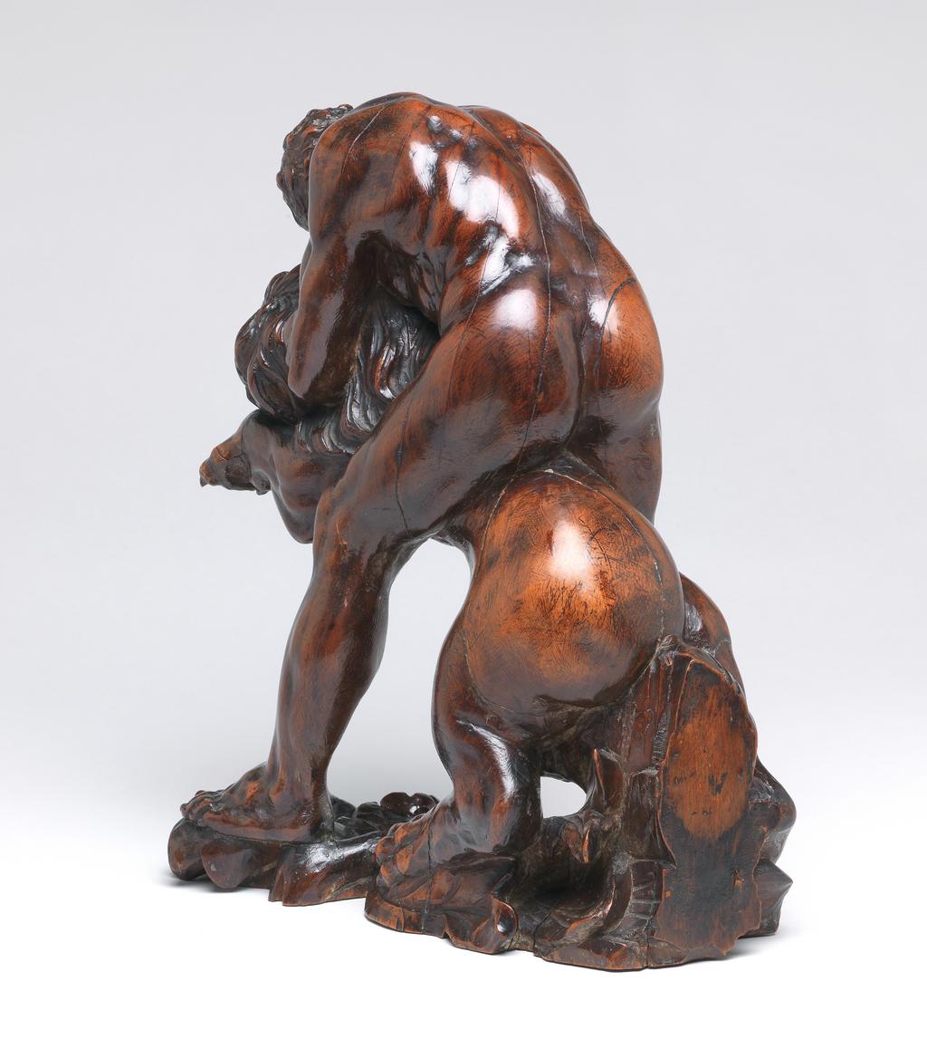 An image of Sculpture/Figure. Hercules and the Nemean Lion. Both Hercules and the Nemean lion are facing to the left. He stands astride the lion, with his left leg forward, grasping it round the throat with both arms and forcing it backwards so that both its front paws are in the air. The narrow base is carved with foliage which rises up to support the lion's rear quarters, and is there cut off. Fruitwood, carved in the round, and with a highly polished surface, height, whole, 25.0 cm, length, whole, 24.6 cm, after 1550, second half of the 16th century of later. Attribution: Purchased by Boscawen as School of Michelangelo or perhaps Bertoldo.