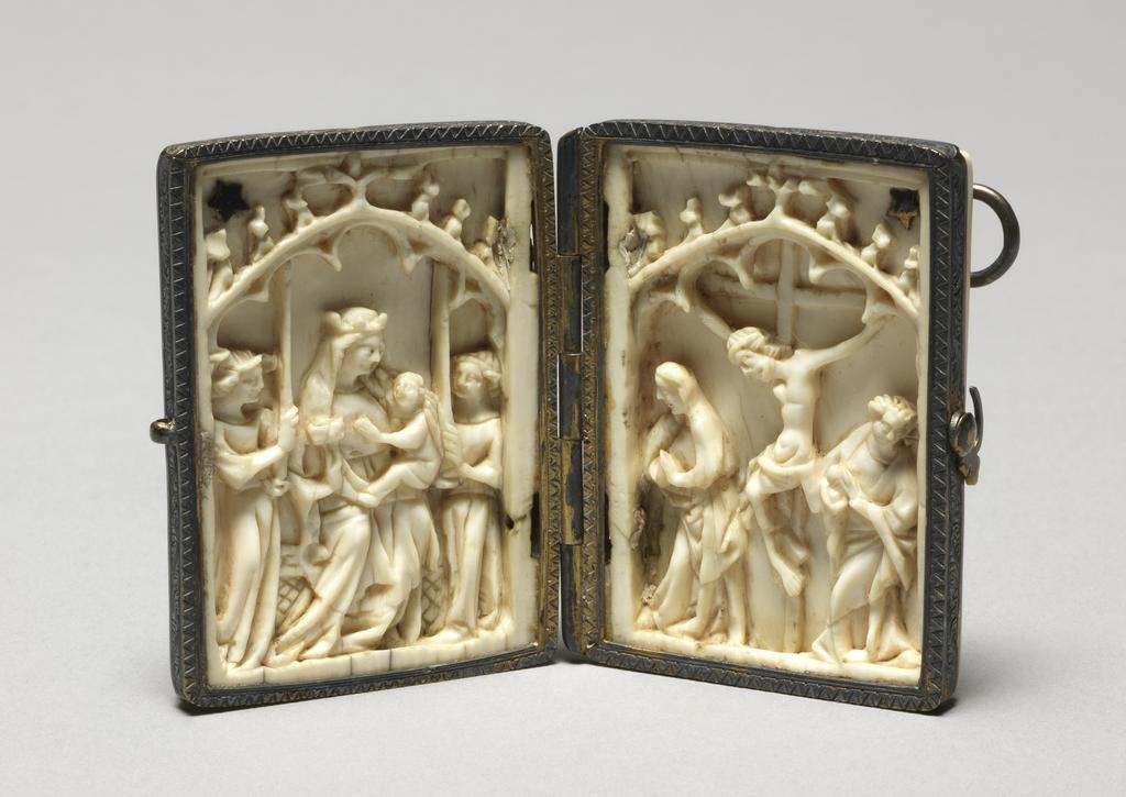 An image of Sculpture / Diptych. Left wing: Virgin and child enthroned with two angels holding tall candles. Right wing: Crucifixion with Virgin and St John. Both scenes are placed under a crocketted and cusped arch. Ivory, carved, height, whole, 5.2 cm, width, whole, 7.9 cm, 1300-1400. Gothic, Medieval. Production Place: France.