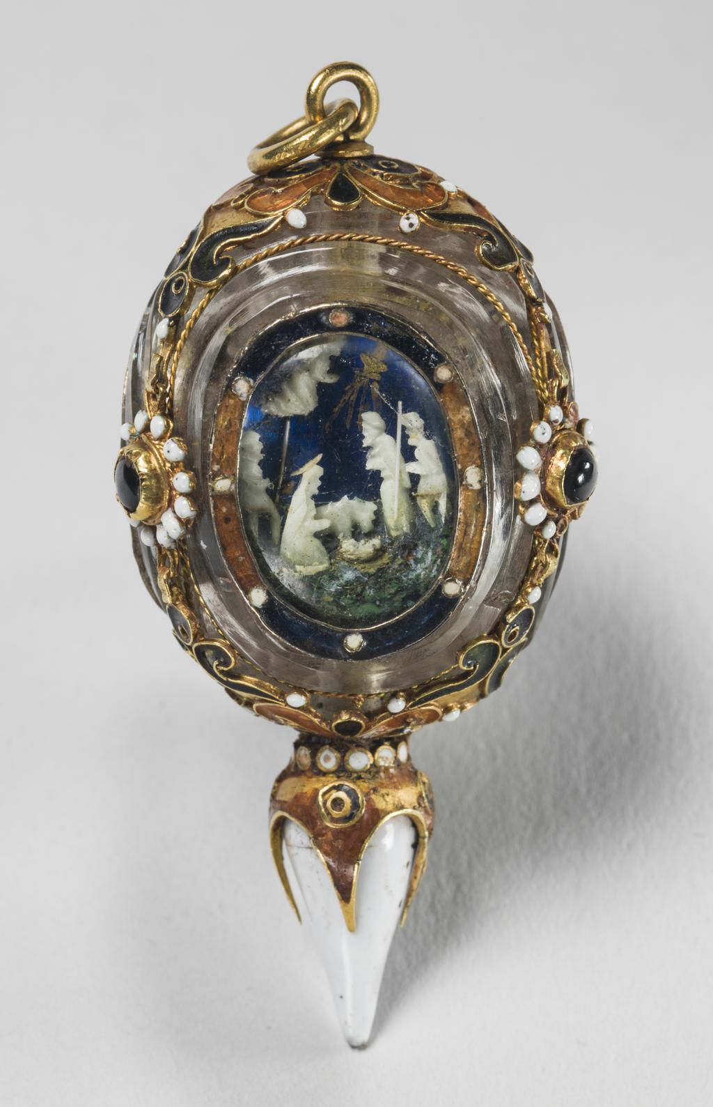 An image of Pendant/ Jewellery. Unknown Maker, Spanish. Triangular with three jewels and oval panels containing against a blue background three scenes from the life of Christ, the Adoration of the Shepherds, the Crucifixion and the Resurrection - the figures in white, the drop also being white enamel over the gold. Enamelled gold and crystal, height, whole, 5.1, cm, circa 1500-1660. Renaissance.