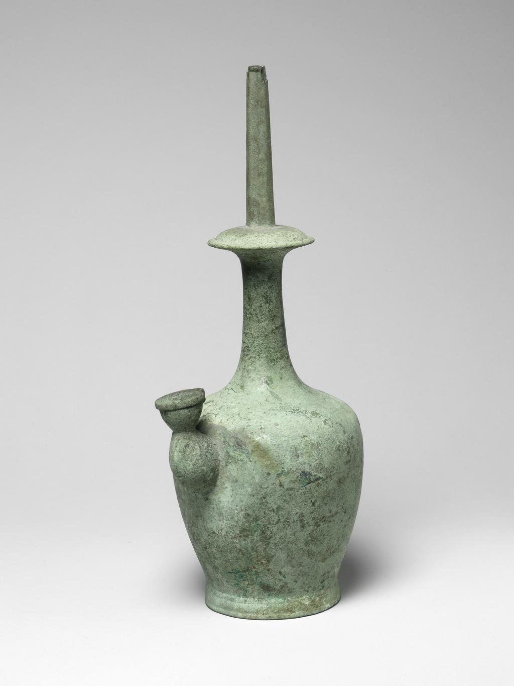 An image of A bronze Kundika of usual shape with octagonal spout, lid on lateral spout intact, covered with even pale-green patina. Circa 935-1392. Korean.