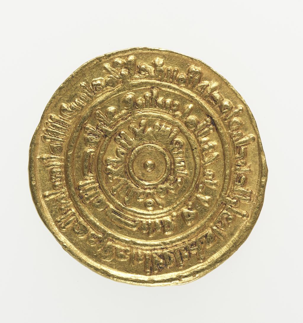 An image of Coinage. Dinar. Al-Mustansir (1036-94), ruler, Egypt. Misr mint, Egypt. Egypt and Syria. Fatimids. Obverse; Plain circle with a dot in the middle, 1st margin in plain circle, 2nd margin in plain circle, 3rd margin. Reverse; Plain circle with a dot in the middle, 1st margin in plain circle, 2nd margin in plain circle, 3rd margin. Gold, height 21 mm, width 21 mm, weight 4.17 g, 1054-1055. Islamic.