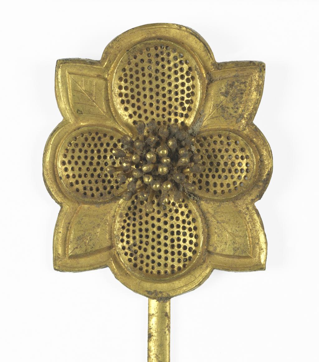 An image of Hairpin. Unknown maker, China. Gold hair pin the head in shape of a flower with four petals pierced and for engraved with veining and is soldered to a long pin. Gold, length, 21.6, cm, width, 3.8, cm, circa 907. Chinese T’ang or early Sung Dynasty.