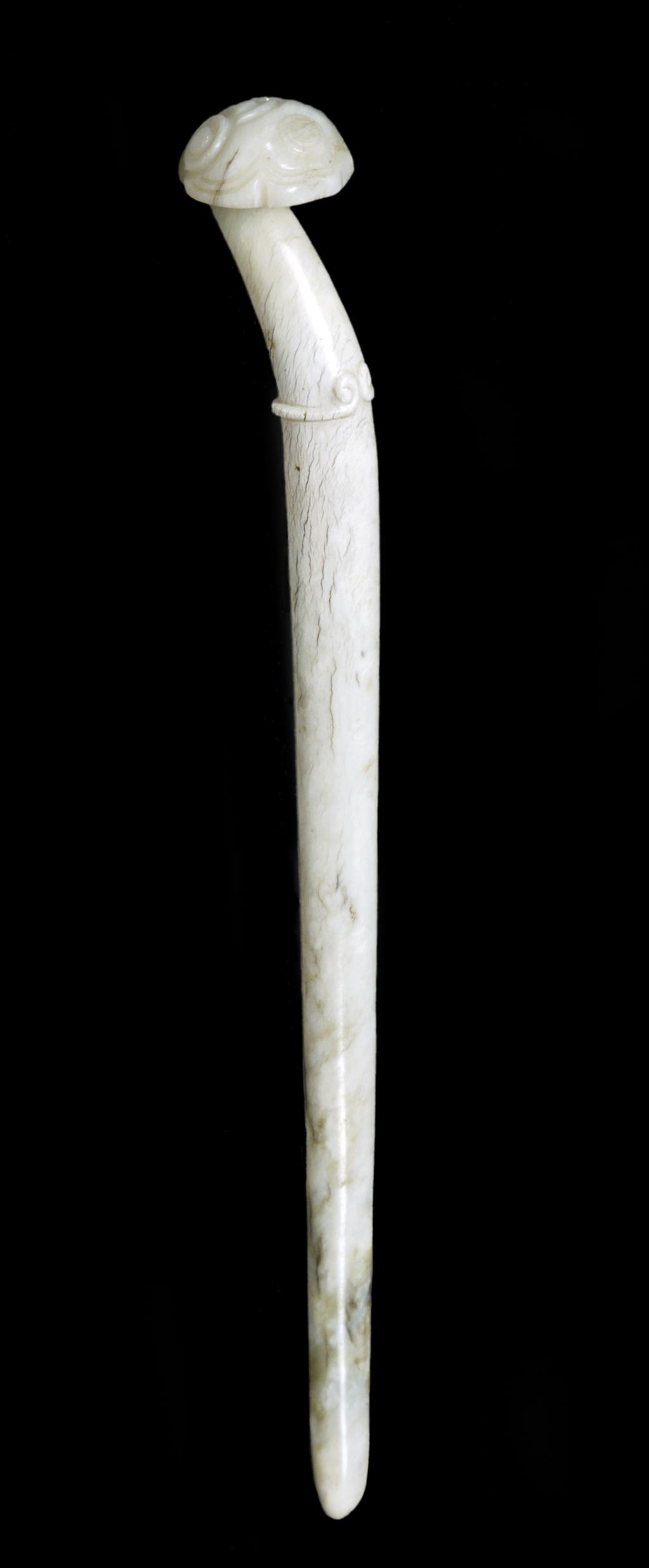 An image of Hairpin. Opaque white jade with grey line inclusions. This pin tapers to a round tip, which is decorated with clouds. Underside flat and undecorated. Nephrite, length 13.2 cm, 1500-1600. Chinese.