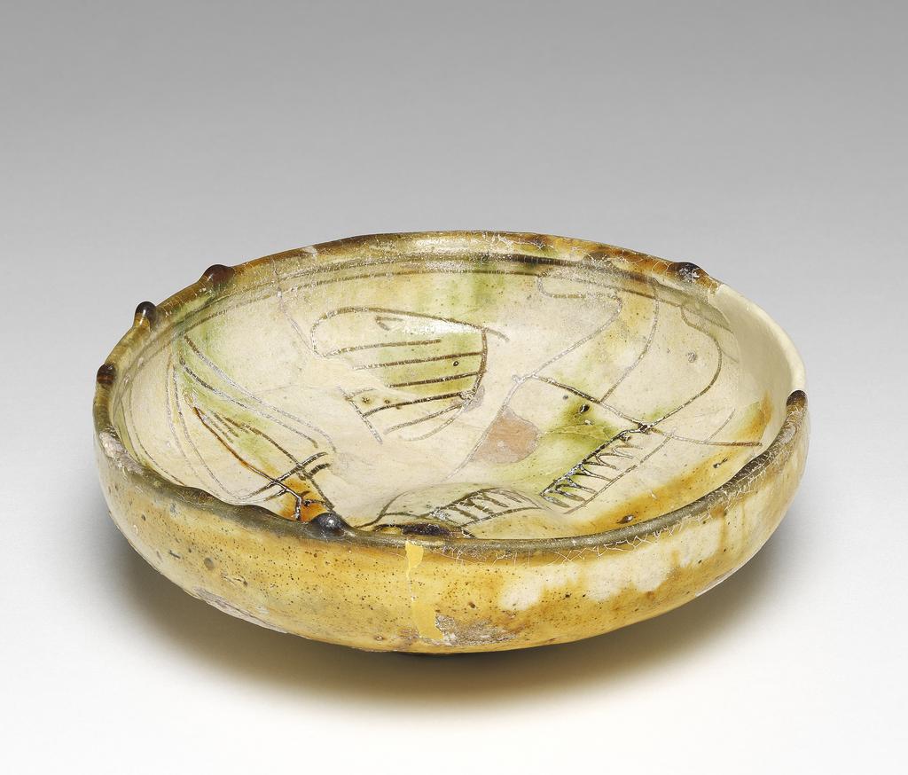 An image of Bowl. Unknown maker, Cyprus. Earthenware, coated with white slip. With decoration scratched through it under a polychrome coloured glaze, 1400-1599.