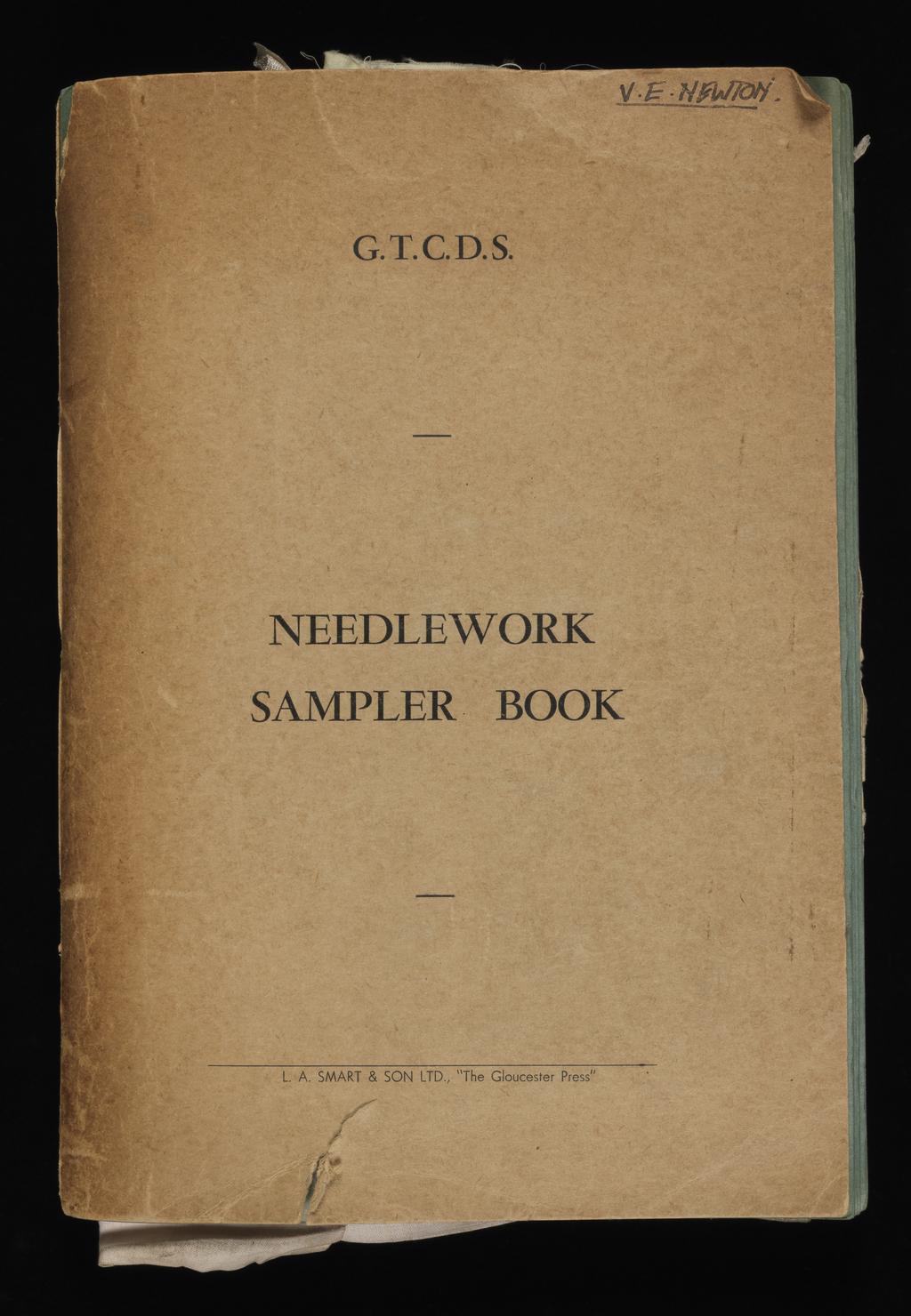 An image of Needlework Sampler Book. Newton, V. E. (British). With a series of exercises worked by V. E. Newton whilst a student at the Gloucestershire Training College of Domestic Science. Cardboard, fabrics and cotton. 1930-1939.