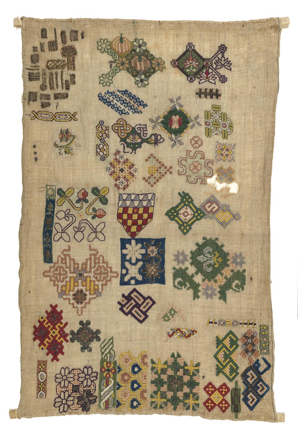 An image of Embroidery/Spot motif sampler. Unidentified Maker. Probably worked by Mary (b. 1608), daughter of Amyas Chichester; or Mary (b. 1615) or Margaret (b. 1619), daughters of Henry Chichester of Arlington Devon. Embroidered on linen with polychrome silks in tent, cross, long-armed cross, back, chain, eyelet, rococo and faggot stitch with pulled work. Silver and silver-guilt thread is worked in braid and interlacing stitches, and there is laid and couched work with one spangle. Three of the edges are hemmed and there is a selvedge with a single blue line on the right side. Length 42.25 cm, width 27 cm, circa 1620-circa 1640. England, Devonshire.