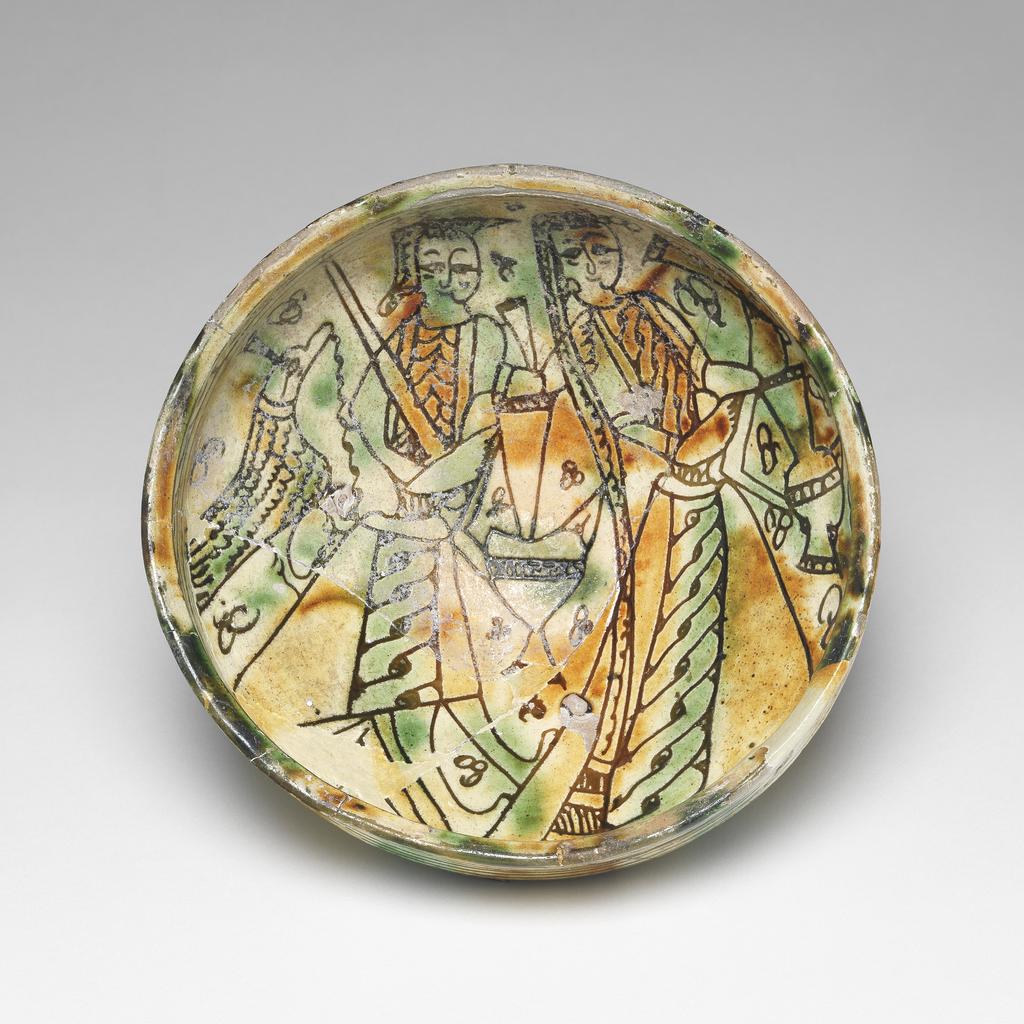An image of Bowl, possibly a marriage bowl. Unknown maker, Cyprus. In the centre are two figures, of a man and woman. Earthenware, With a polychrome coloured glaze, height 8.6 cm, diameter 15.5 cm, 1300-1499.