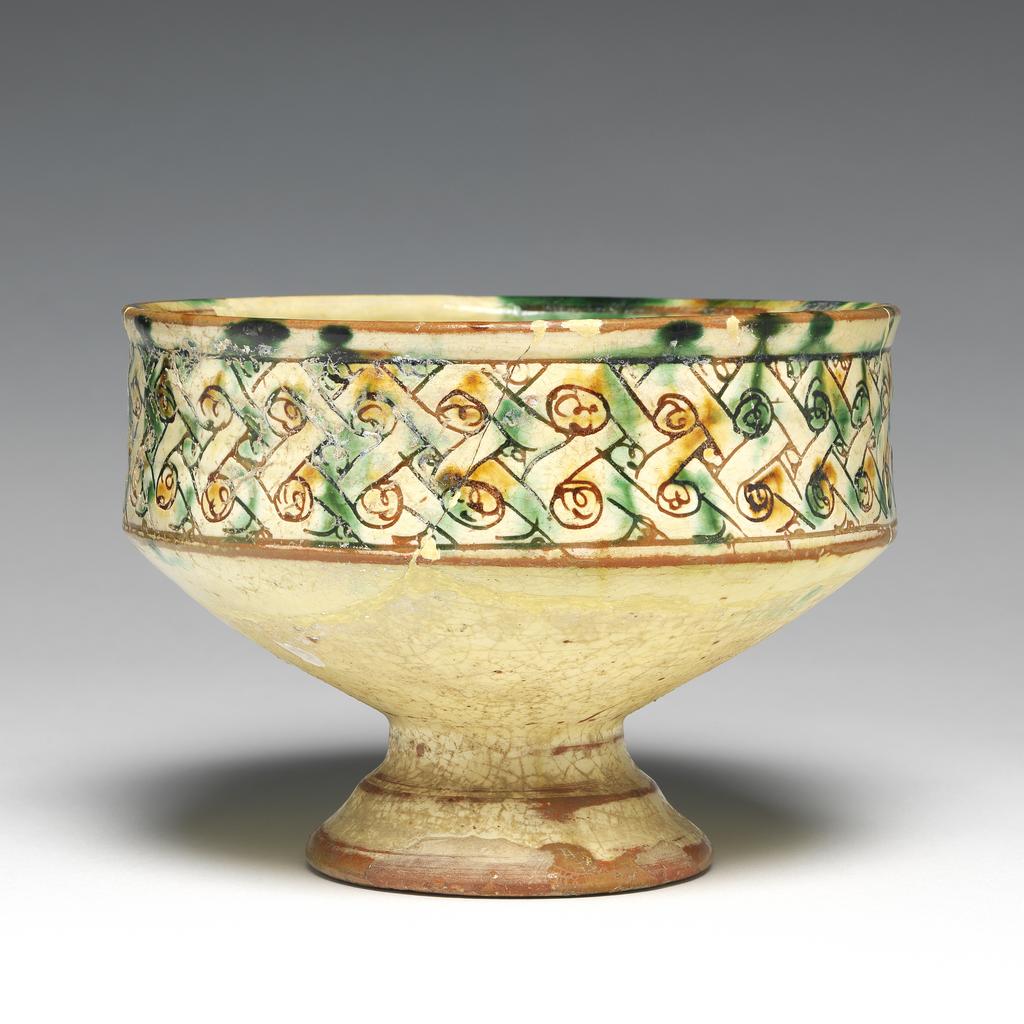 An image of Bowl. Unknown maker, Cyprus. Decorated with a grotesque animal or bird. Earthenware, height 8.5, cm, width 14 cm, 1300-1499.
