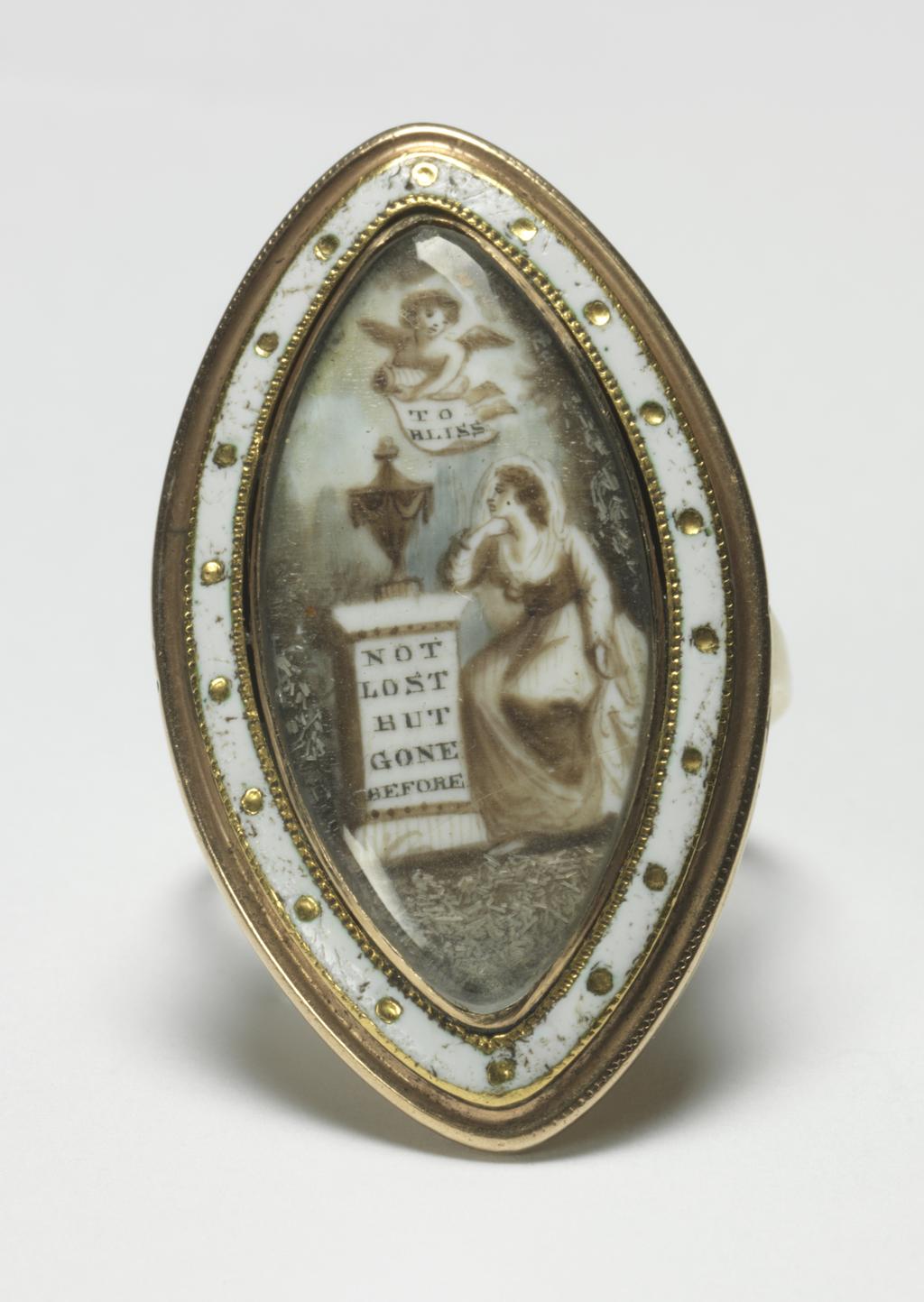 An image of Jewellery. Ring/Mourning Ring. Thin, narrow hoop expanding at the shoulders. Marquise shaped bezel with enamel border, gold dots reserved in white enamel. Under glass a painting on ivory of a woman seated by an urn, which is on a pedestal bearing the inscription: 'NOT LOST BUT GONE BEFORE'. Above the pedestal a cherub holds a scroll inscribed: 'TO BLISS'. On the back of the bezel is the inscription: 'Garsford Gibbs Obt 25 Dec 1788 aet 15'. Height, whole, 1.25 mm, depth, whole, 1.0 mm, length, whole, 20.5 mm, height, bezel (marquise) 4.5 mm, width, bezel (marquise) 19.0 mm, length, bezel (marquise) 33.5 mm, 1788. English.