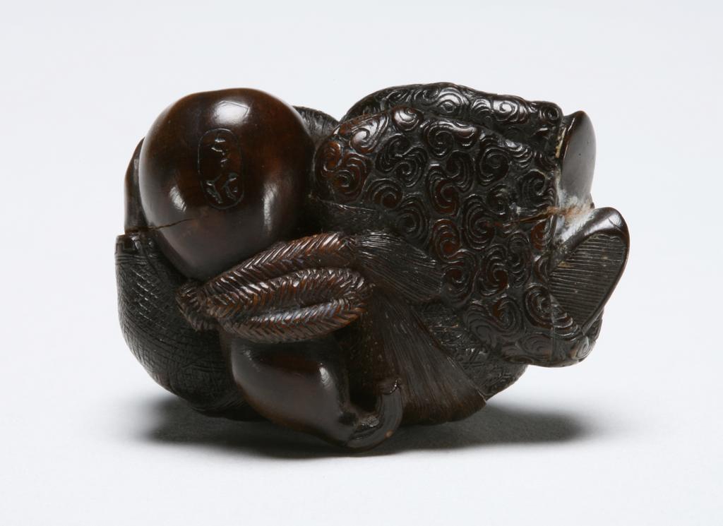 An image of Netsuke: katabori. Sleeping Shojo. Hokutei, Edo Period (1603-1868), Japan. Figure of Shojo curled up and sleeping, her head and hands resting on a double gourd flask, the stalk forming the himotoshi. Details of her hair and costume finely incised. Wood, finely carved, incised and stained, height, whole, 2.6 cm, width, whole, 3.9 cm, circa 1800-1868. Edo Period (1615-1868).