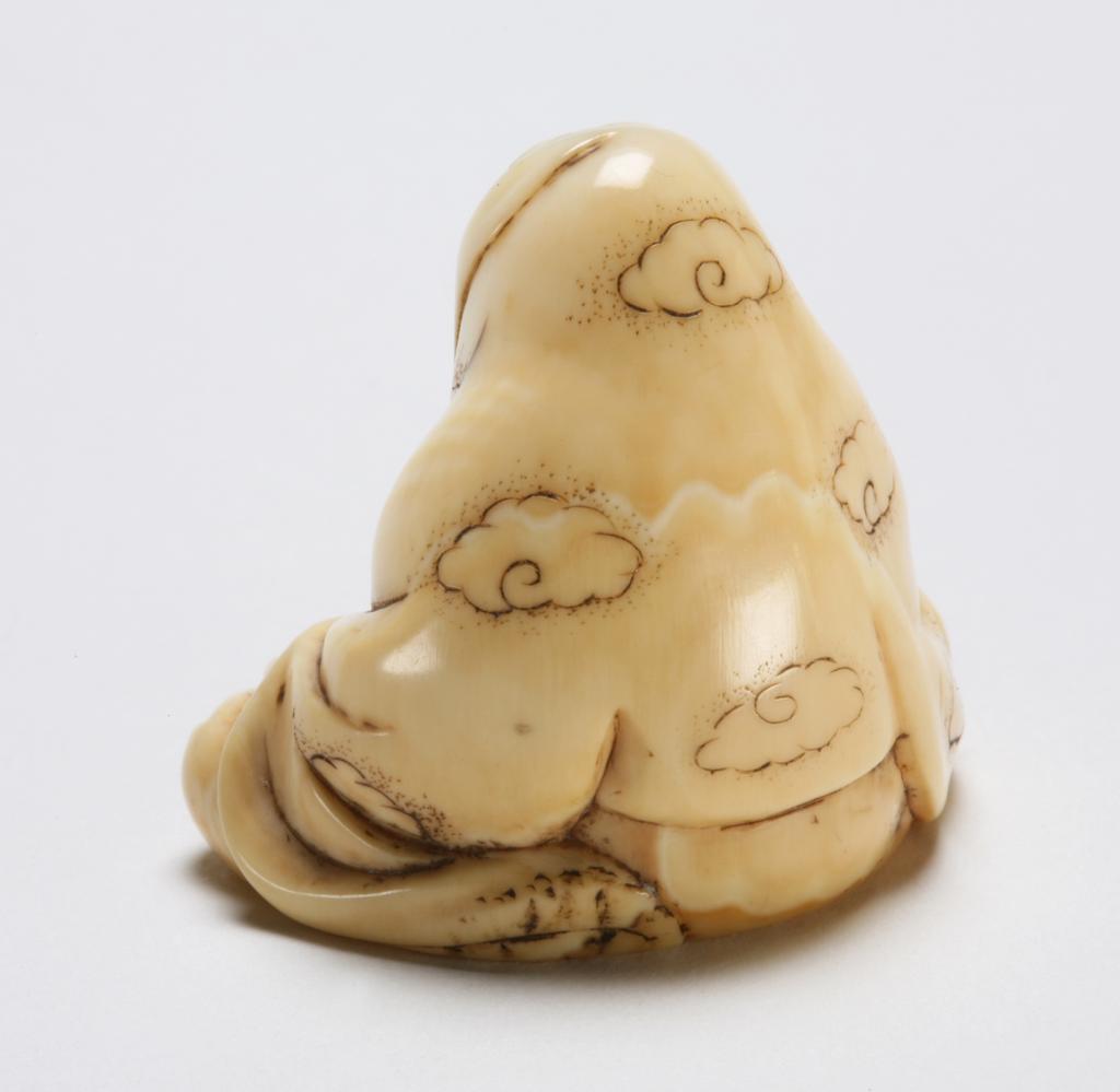 An image of Netsuke. Katabori. Daruma. Ryusui, Edo School, Edo Period (1603-1868), Japan. Figure of Daruma sitting cross-legged, his hands resting on his knees and yawning during his nine year meditation His robe covers his head and is decorated with clouds. Himotoshi through the base. Ivory, carved and stained, with traces of red paint, height, whole, 3.5 cm, width, whole, 3.6 cm, circa 1800-1868. Edo Period (1615-1868).