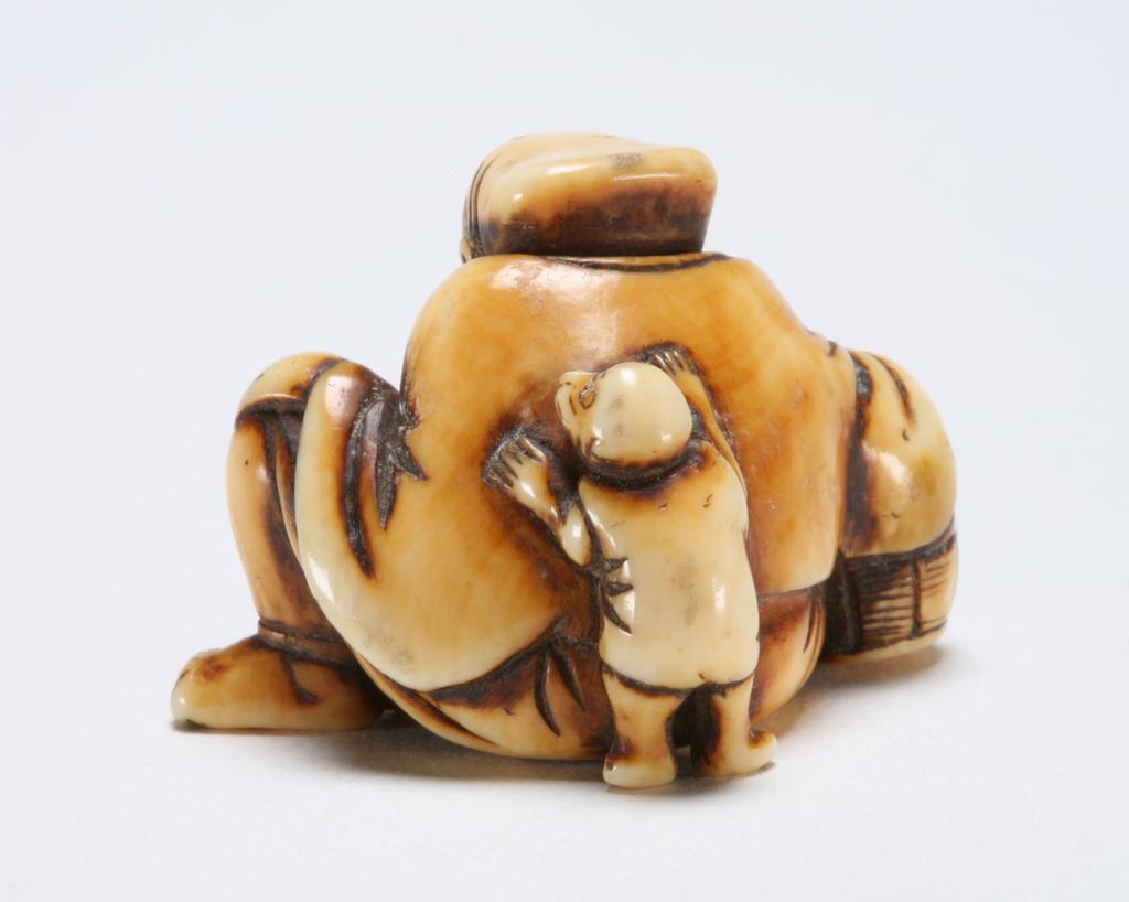 An image of Netsuke: katabori: Monkey-trainer. Unknown maker, Japan.  Ivory, carved and stained. Figure of a man (sarumawashi) seated, leaning his right arm on a barrel and resting his left hand on his left knee, his small monkey climbing up his back. Himotoshi on the underside. Ivory, carved and stained, height, whole, 2.9 cm, width, whole, 3.5 cm, circa 1800-1868. Edo Period (1615-1868).