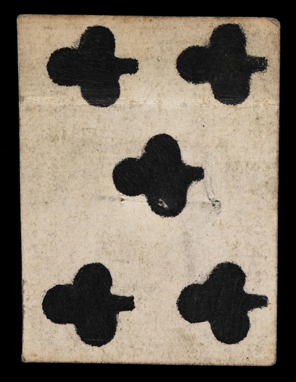 An image of Fragment of the Ten of Clubs. The upper half of the card, with the upper edge also missing. Five out of the ten pips are present. The position of the central pip in the upper portion of the card indicates that there would have been a second pip below and confirms the card as the Ten of Clubs rather than the Nine of Clubs. There is a crease across the card where it has been folded. There are two holes at the centre, which are most likely stitching holes relating to the secondary use of the card as a stiffening material in bookbinding. See W.M. Fletcher, who describes other playing cards and MSS found near staircase A at Trinity College in 1902 which are ‘pierced with stitching holes containing fragments of thread’ and states that, ‘These no doubt represent some rubbish from destroyed book bindings, for it should be remembered that this staircase provided a back way to the College Library when it was housed in this block’. Hand-coloured woodcut on pasteboard. French, 17th century.