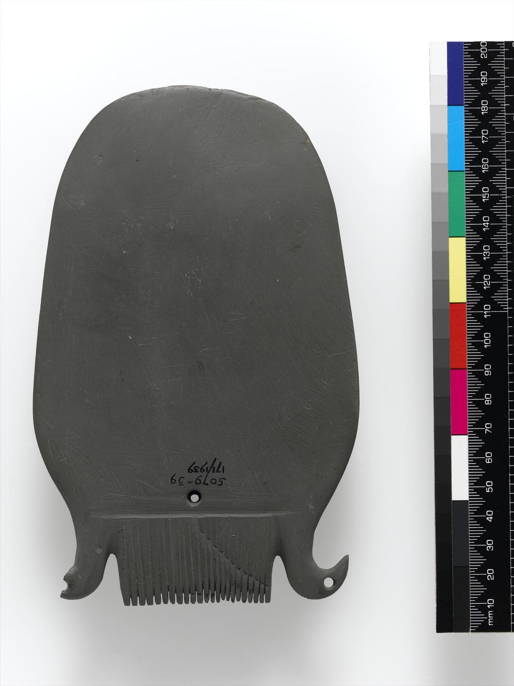 An image of Cosmetic equipment. Palette, with two bird heads and comb at top. Production Place/Find Spot: Egypt. Length 0.175 m.