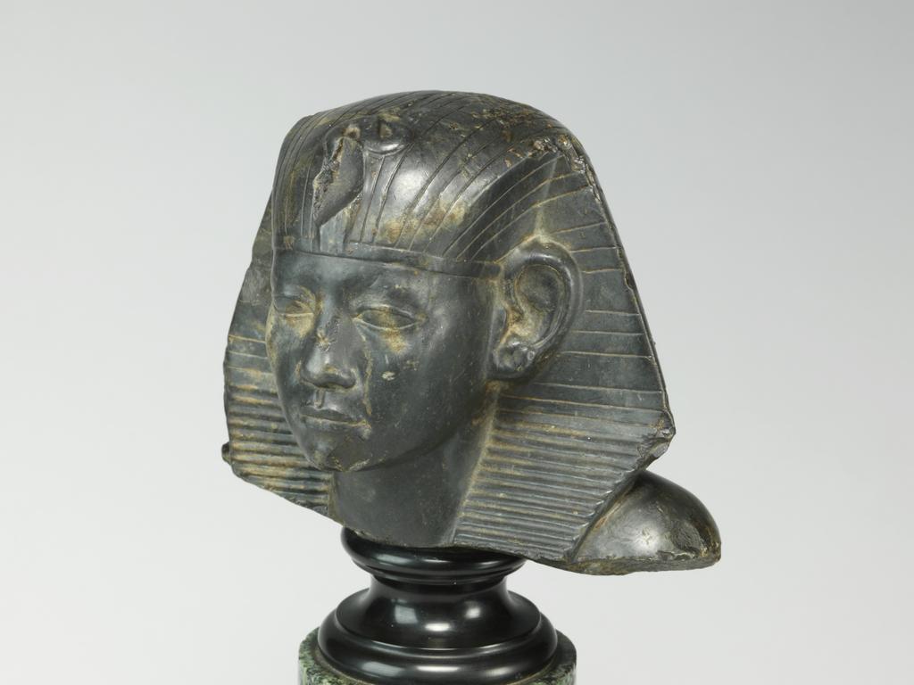 An image of Statue/Figure. Head of King Amenemhet III, wearing nemes head-dress. Find Spot: Aswan, Egypt. Shelly limestone, length 12 cm, width 14.3 cm, circa 1831-circa 1786 B.C. Twelfth Dynasty, Middle Kingdom. Reign of Amenemhat III. Production Notes: Only the shoulders and head are preserved; the base is modern. The statue was found in a private tomb. The facial features are a softer version of the so-called 'realistic portraits' of Senusret III. In this way the ruler was able to promote a visual link to his predecessor.