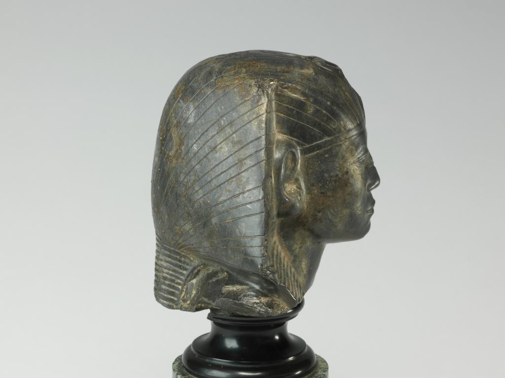 An image of Statue/Figure. Head of King Amenemhet III, wearing nemes head-dress. Find Spot: Aswan, Egypt. Shelly limestone, length 12 cm, width 14.3 cm, circa 1831-circa 1786 B.C. Twelfth Dynasty, Middle Kingdom. Reign of Amenemhat III. Production Notes: Only the shoulders and head are preserved; the base is modern. The statue was found in a private tomb. The facial features are a softer version of the so-called 'realistic portraits' of Senusret III. In this way the ruler was able to promote a visual link to his predecessor.