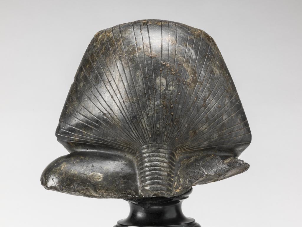 An image of Statue/Figure. Head of King Amenemhet III, wearing nemes head-dress. Find Spot: Aswan, Egypt. Shelly limestone, length 12 cm, width 14.3 cm, circa 1831-circa 1786 B.C. Twelfth Dynasty, Middle Kingdom. Reign of Amenemhat III. Production Notes: Only the shoulders and head are preserved; the base is modern. The statue was found in a private tomb. The facial features are a softer version of the so-called 'realistic portraits' of Senusret III. In this way the ruler was able to promote a visual link to his predecessor.