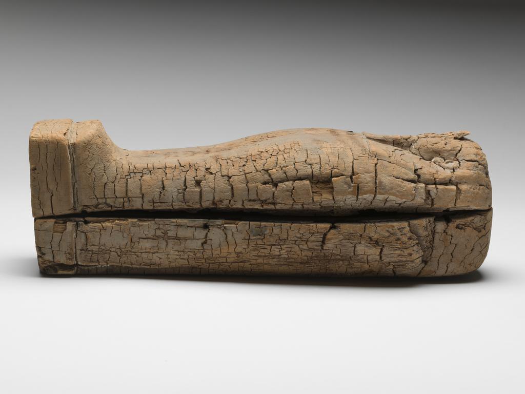 An image of Funerary Equipment. Coffin. Miniature coffin, with embalmed object, possibly the body of an infant, coated in pitch inside. Production Place: Egypt. Find Spot: Gizeh, Egypt. Wood, length 43.8 cm, width 13.4 cm, depth 14.1 cm, circa 664- circa 525 B.C. Dating not confident. Late Period.