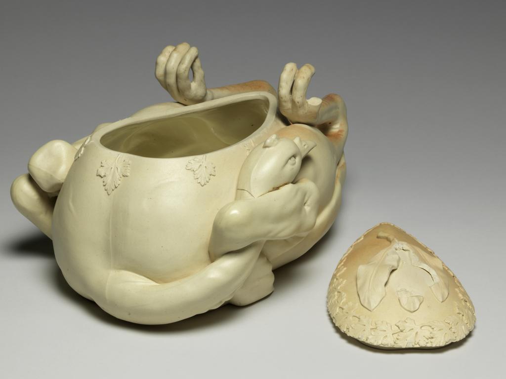 An image of Tureen and cover. ‘Pastry turkey’ tureen. John and William Turner, pottery, Staffordshire, Longton, Lane End. Moulded in the shape of a trussed and roasted fowl or game bird, breast upwards, with upturned feet and head tucked under one wing and egg-shaped cover fitting into breast. There is a relief moulded parsley garnish around the junction of the cover and body, and three moulded bay leaves which form a handle for the cover. Faint reddish-brown staining suggests roasting on parts of the upper surface. The interior is glazed. The underside is very slightly concave, with a narrow foot-rim. Cream stoneware, moulded, modelled and decorated with applied reliefs, height, whole, 15.5 cm, approx, length, whole, 33.6 cm, width, whole, 20.0 cm, approx, circa 1800. Production Note: Not dated, but social circumstances at this time indicate c.1800 the most likely date. Other examples dated c.1780-c.1820.