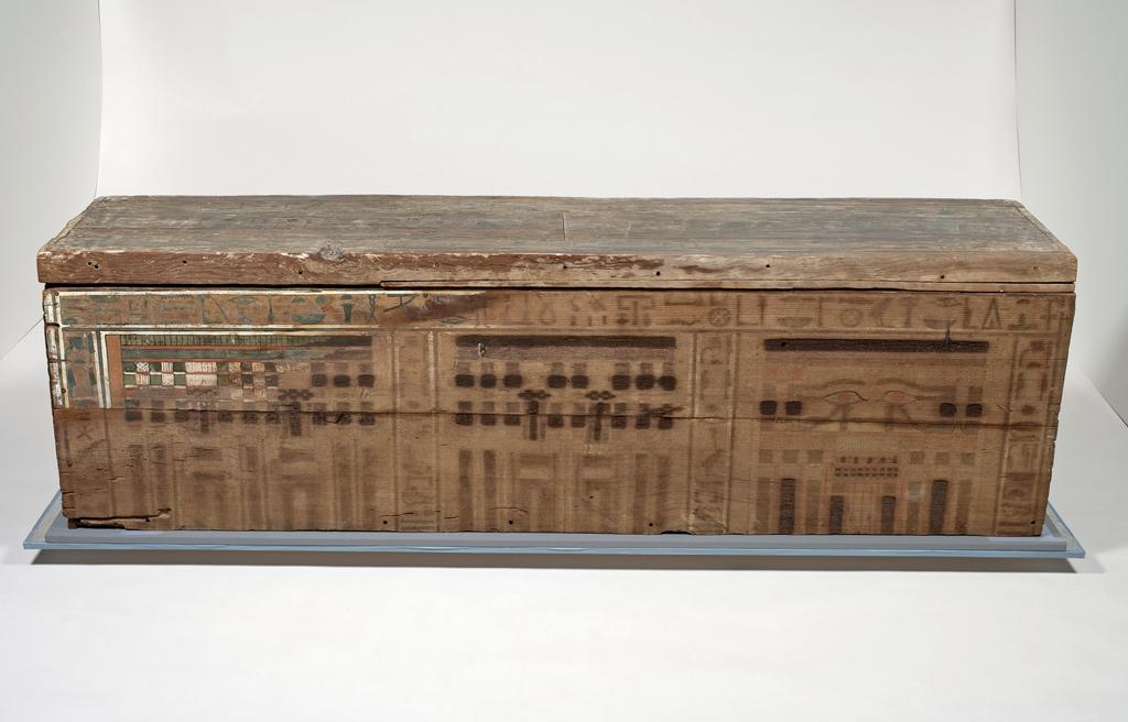 An image of Funerary Equipment. Coffin, with lid. Inscribed for a woman with the title 'Lady of the House' called Nakht. Production Place: Egypt. Find Spot: Beni Hasan; tomb 23. Wood, painted, height 0.545, m, length 1.855, m, width 0.438, m, 1985-1773 B.C. Twelfth Dynasty. Middle Kingdom.