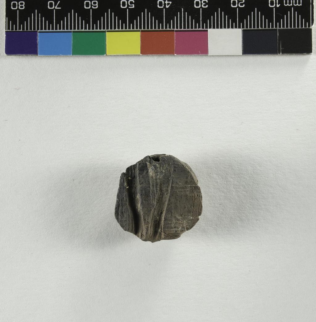 An image of Written document. Seal impression. Sealing from a papyrus roll, faint signs visible. Production Place/Find Spot: Egypt. Diameter 0.025 m.