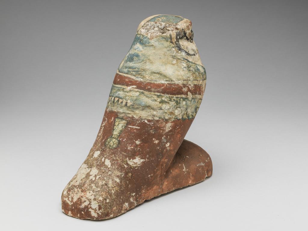 An image of Funerary Equipment/Figurine. Mummified falcon figure. Production Place: Egypt. Wood, height 0.165 m.