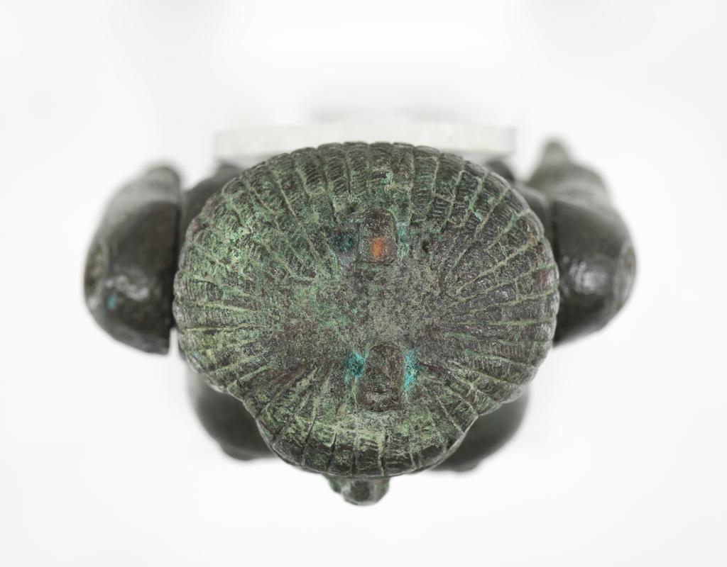 An image of Figure/Statuette. Production Place: Egypt. The prominent pubic triangle suggests that the figure was associated with fertility. Such representations were found in graves as early as the Middle Kingdom; during the earlier periods such objects were typically made from wood, clay, ivory or bone. A connection to fertility would explain why the subject is naked- this is extremely rare in Egyptian art. This figure has moveable arms, inlaid eyes (now missing) and once wore a headdress or crown, as indicated by the tenon on top of the head. The short wig identifies the subject as Nubian (southern Egypt or Sudan) and the rounded, broad face suggests that the female was African. The figure was hollow cast in several pieces and is in good condition. Copper alloy, body cast hollow in one piece, arms cast separately, obsidian pubic triangle inlay, height 21.8 cm, circa 747- circa 656 B.C. Twenty-fifth Dynasty.