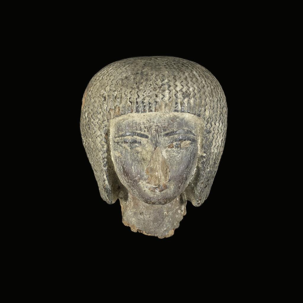 An image of Figure/statue. Female head. Production Place: Egypt. Wood, painted, depth 0.05 m, height 0.06 m, width 0.05 m.