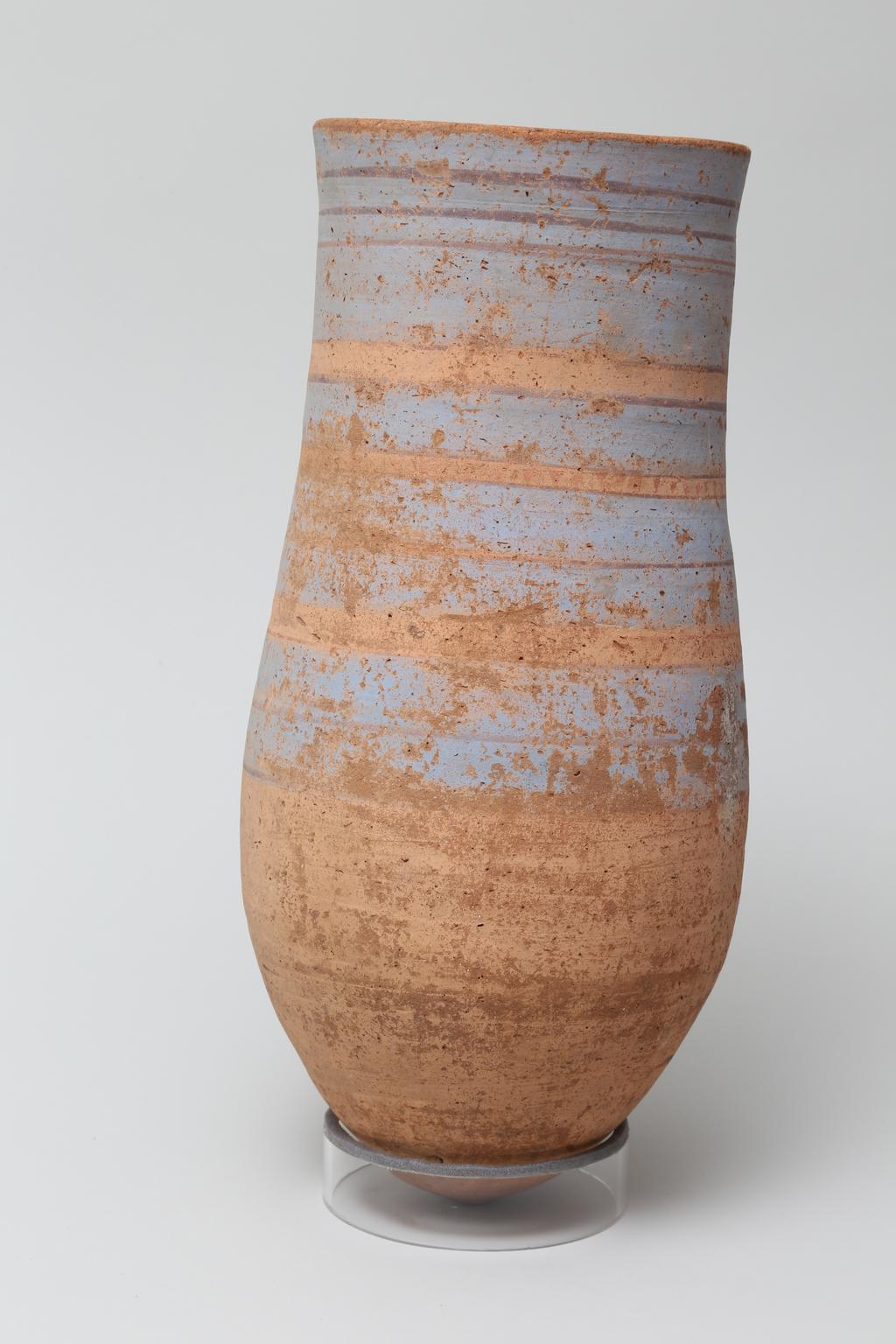 An image of Vessel. Necked jar, with 4 bands of blue and 12 lines of red decoration. Production Place: Egypt. Find Spot: Abydos ? Egypt. Height 0.35 m.