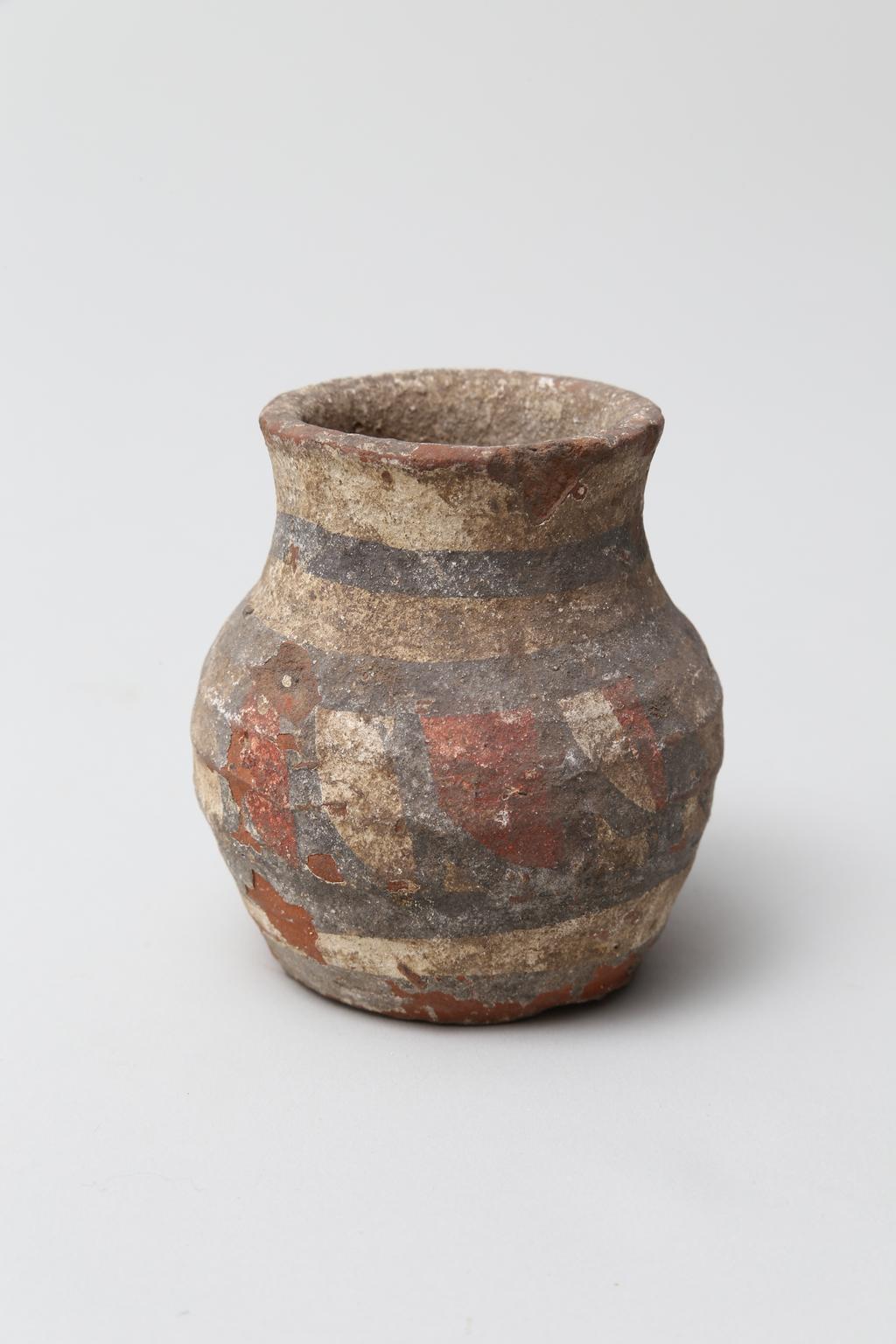 An image of Vessel. Jar, with decoration in black and red paint. Find Spot: Abydos?, Egypt. Production Place: Egypt. Height 0.065 m.