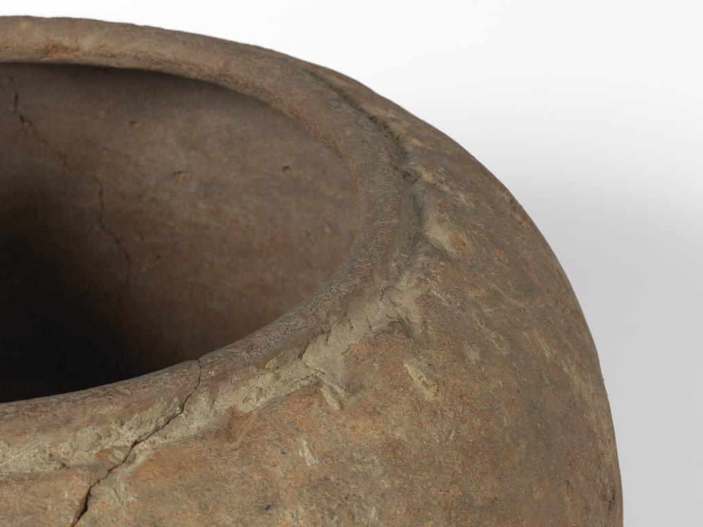 An image of Clay vesselThe skeleton found in this jar was that of a child. A flint and a couple of pottery vessels accompanied the body.C.-2707 - 2170