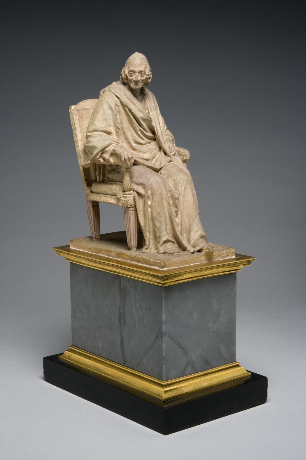 An image of Sculpture/Figure. François Marie Arouet, known as Voltaire (1694-1778). Houdon, Jean-Antoine (French, 1741-1828). Terracotta, supported on a pedestal of grey and black marble with gilt-bronze mouldings, circa 1778.