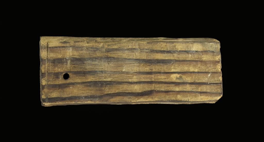 An image of Written document. Mummy label, Greek. Production Place: Egypt. Wood, length 0.118 m, width 0.045 m. Middle Roman Period. 101 - 200.