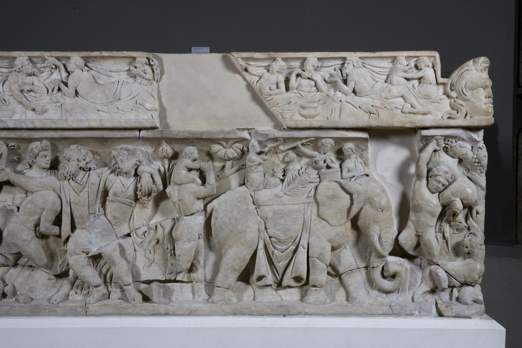 An image of Funerary Equipment. Pashley Sarcophagus, with relief showing triumphal return of Dionysos. Carved Luna Marble, height 0.697 m, length 2.22 m, weight 1.4 tonne, width 0.67 m. 101-200 AD, Middle Roman Period. Find Spot: Arvi Crete Greek Islands.