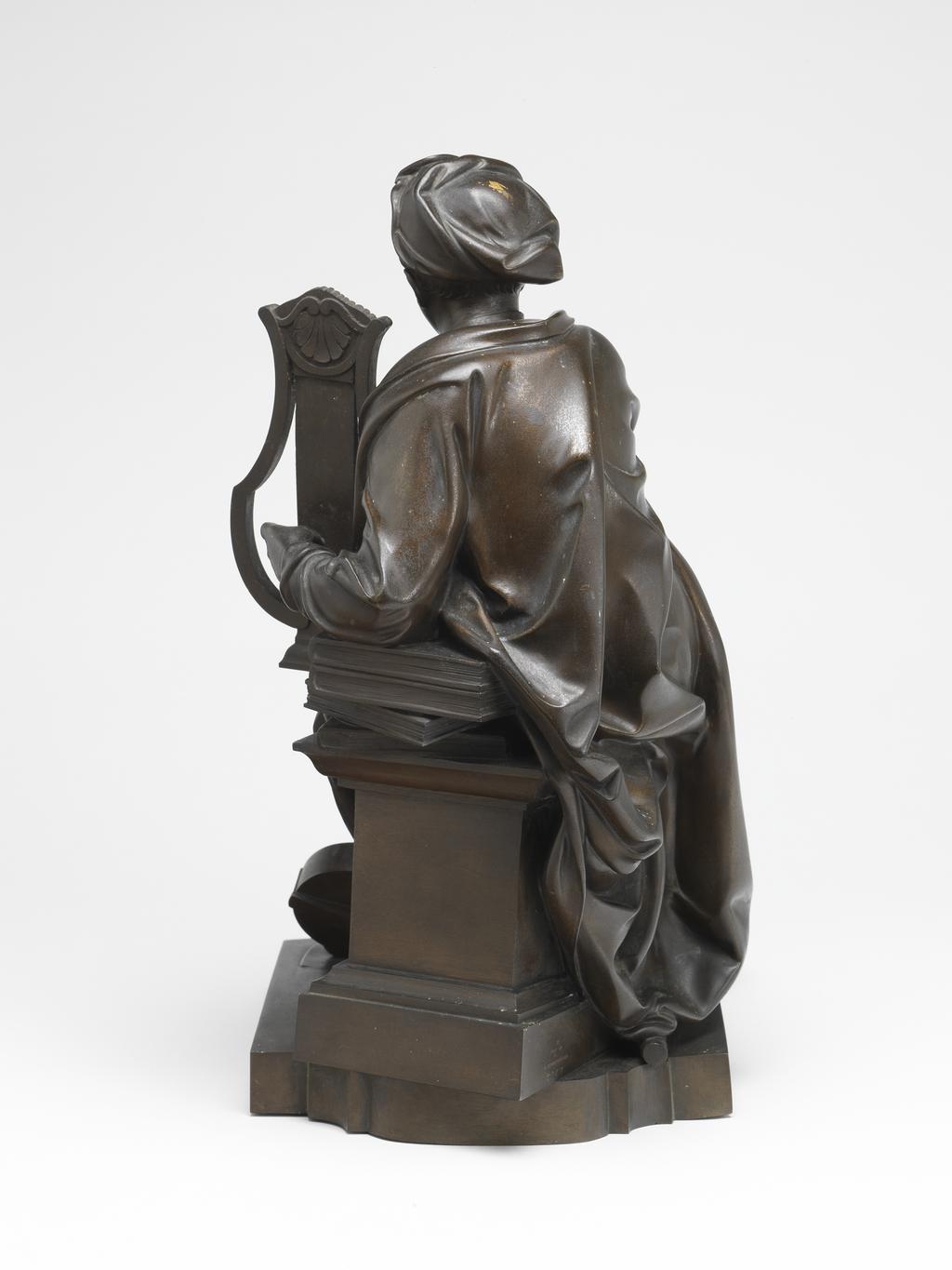 An image of Sculpture/Figure. George Frideric Handel as Apollo. Elkington & Co., England. Roubiliac, Louis François, after (French, 1702-1762 ). Reduced copy of the marble by Roubiliac. The pedestal is inscribed on the front. Bronze electrotype, height, figure, 34.5 cm, width, figure, 18.3 cm, diameter, figure, 27.3 cm, height, base, 20.5 cm, width, base, 20.7 cm, diameter, base, 27.6 cm, circa 1859.