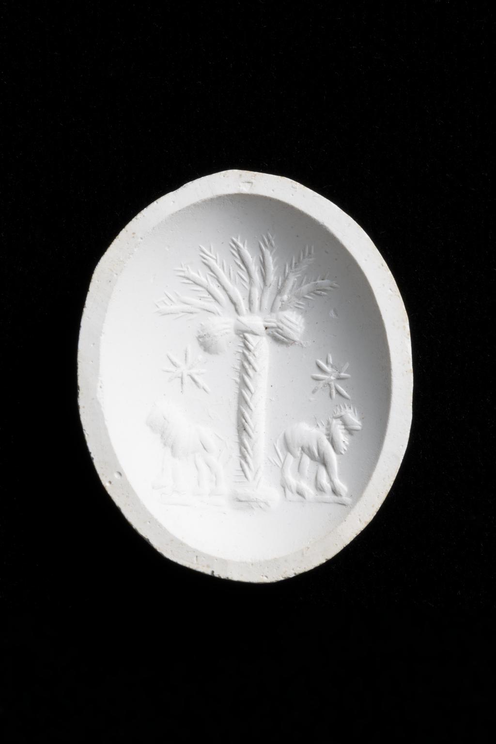 An image of Engraved gems. Magical amulet. Obverse: Helios, palm tree and lion. Intaglio cutting, chalcedony, 201-300 AD. Roman.