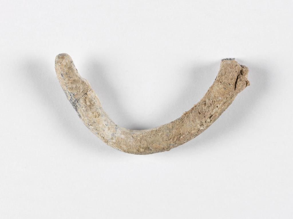 An image of Jewellery. Coil. Find Spot: Marion, Cyprus. Lead, depth 0.005 m, width 0.039 m. Archaic Period.
