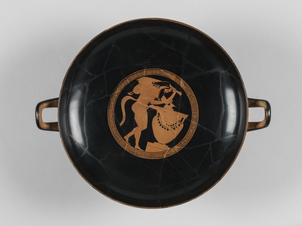 An image of Vessel/Cup. Production place: Athens, Greece. (A) ambush in a wood, warriors with spears (B) warriors, horse, trees (I) satyr with krater. Clay, red-figured, diameter, 0.285 m, height, 0.113 m, width, 0.358 m, height, picture, 0.142 m, 500-450 B.C. Archaic Period.