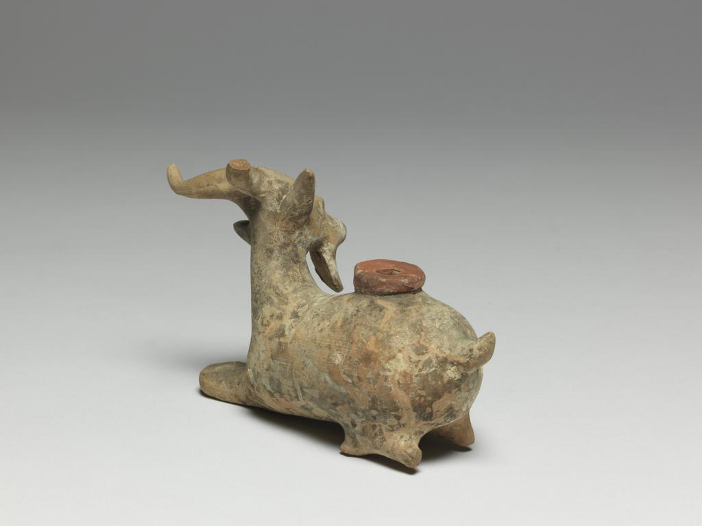 An image of Cosmetic Vessel. Goat, perfumed-oil container. Production Place: East Greece Turkey. Find Spot: Cyprus. Clay, height 0.083 m, length 0.135 m, 600-501 B.C. Archaic Period.