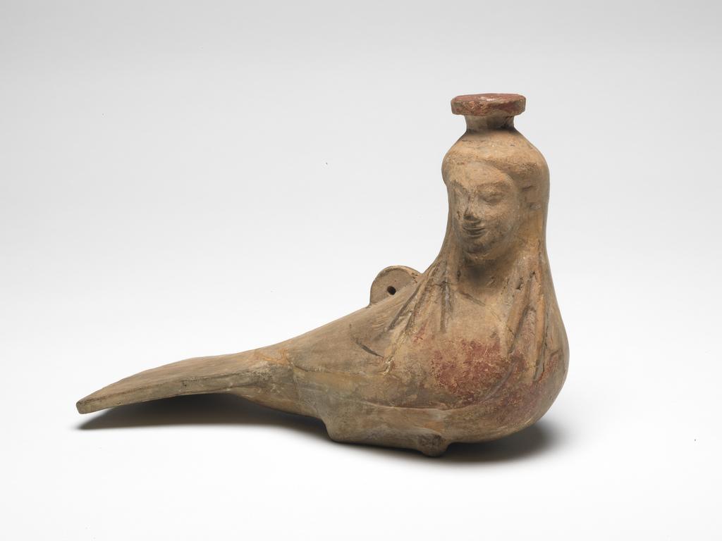 An image of vessel bottle, in the shape of a siren  moulded Field Collection  Rhodes Greek Islands Dimensions width(): 0.074 mheight(): 0.125 mlength(): 0.183 mheight(face): 0.035 m