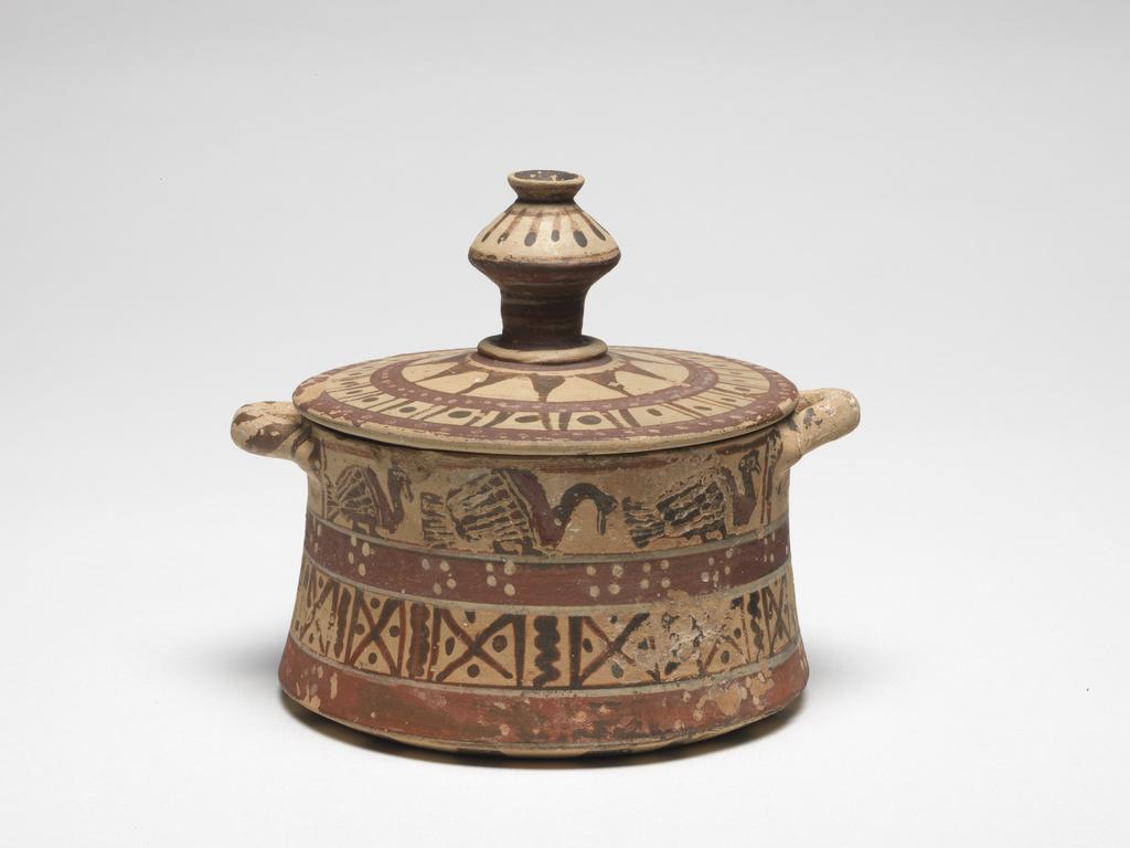 An image of vessel pyxiscosmetic vessel pyxis  Italo-Corinthian Dimensions height 0.094 mheight 0.052 mdiameter 0.113 mdiameter 0.095 m